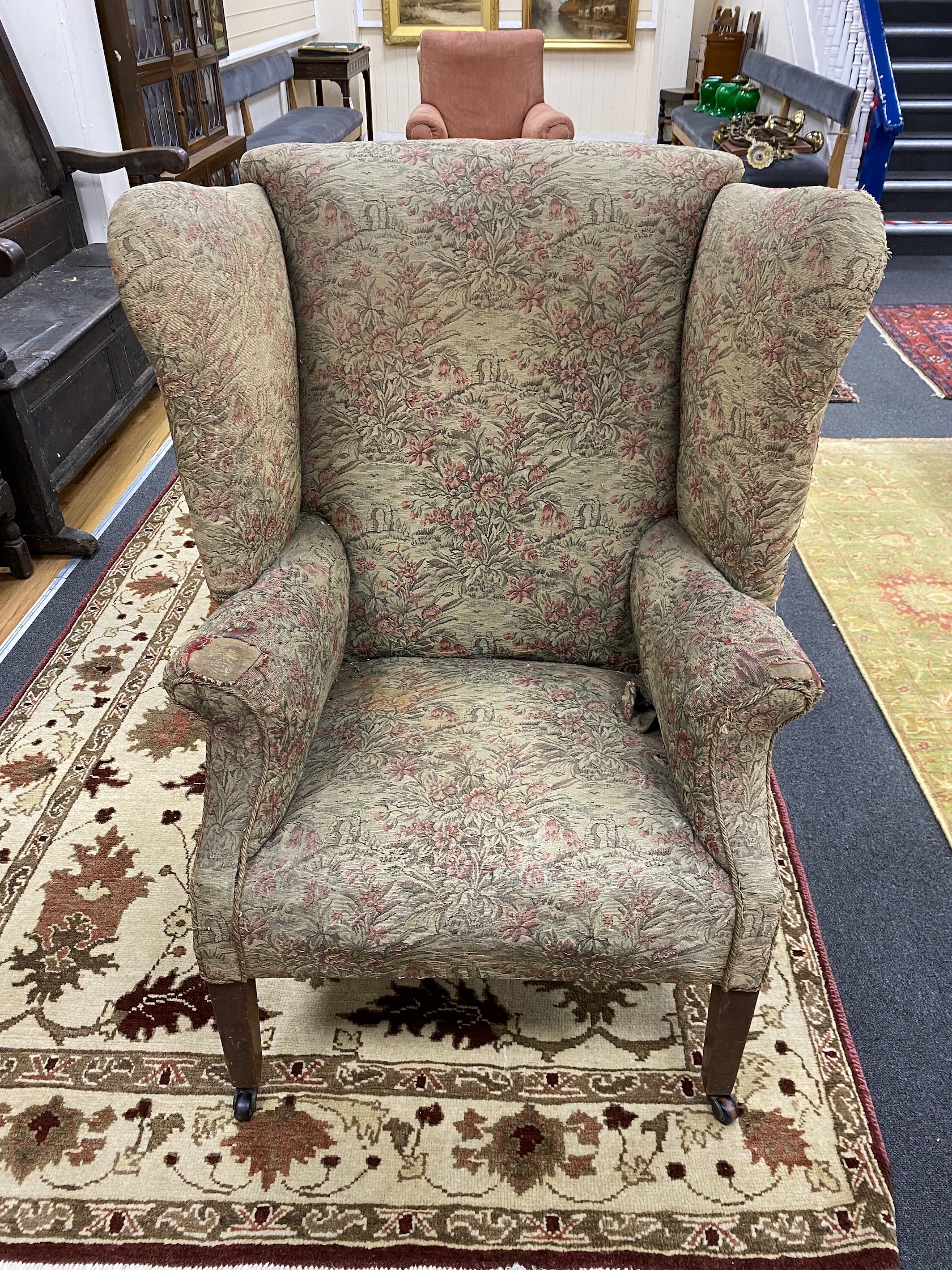 A George III mahogany wing armchair with folding sides, width 86cm, depth 66cm, height 107cm